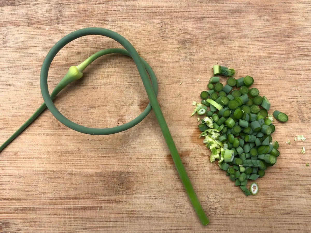 garlic scapes on a cutting board