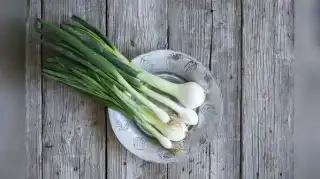 Green Garlic On A Wooden Table